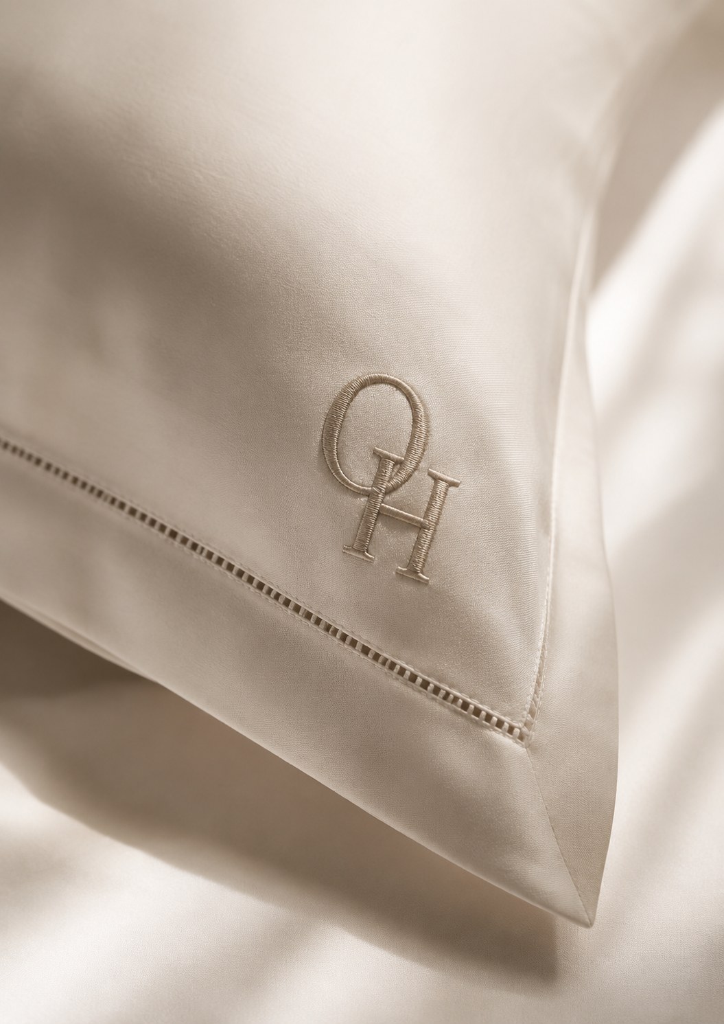 Embroidered OH monogram detail on a pillowcase